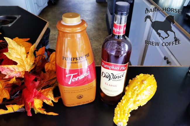Banner Featuring Pumpkin Pie flavored Sauces and Syrups on a counter.