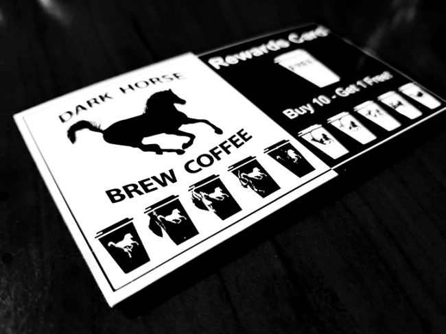Stamp Card 1 Dark Horse Brew Coffee Stamp Card laying on dark counter.