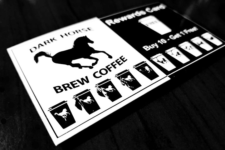 Dark Horse Brew Coffee Stamp Card laying on dark counter.