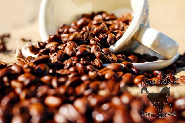 Banner featuring coffee beans spilling from a tipped over coffee mug.